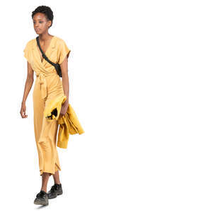 woman in a yellow jumpsuit walking