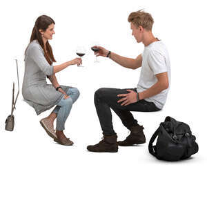 man and woman sitting and drinking wine