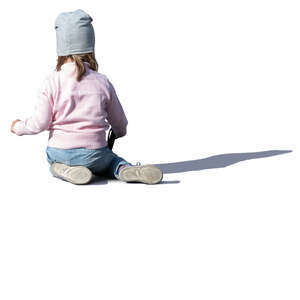 little girl sitting on the ground