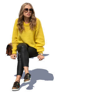 woman in a yellow knit sweater sitting