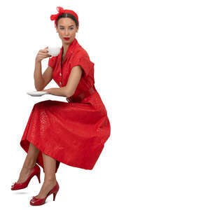 woman in a vintage red dress sitting and drinking coffee