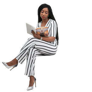 woman in a striped jumpsuit reading a magazine