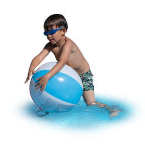 little boy playing with a beach ball in the water