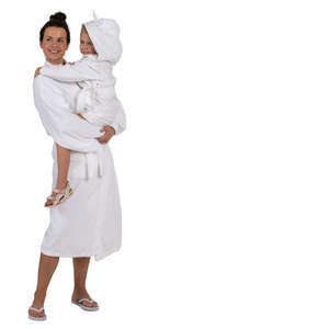 woman in a spa bathrobe standing and holding her daughter