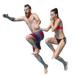 man and woman jumping into the pool together