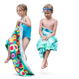 two kids with towels sitting after swimming