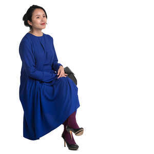 asian woman in a blue dress sitting