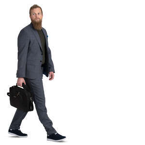 bearded man in a grey suit walking