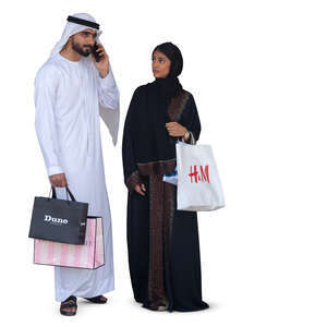 arab man and woman with shopping bags standing