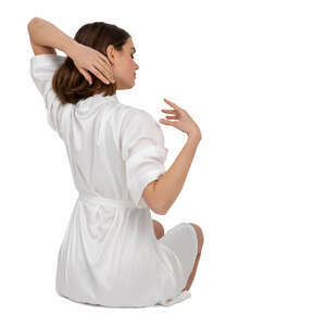 woman in a white bathrobe sitting