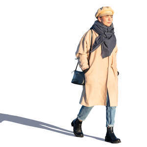 woman in a beige overcoat walking