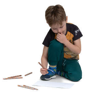 little boy drawing on the floor