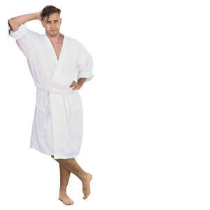 man in a white bathrobe leaning against the wall