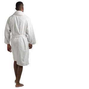 african man in a white bathrobe walking