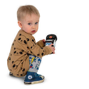 little boy playing with his toy car