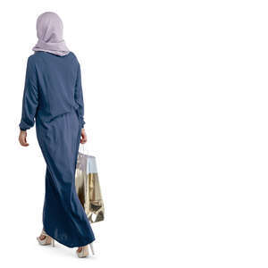 muslim woman with a shopping bag walking