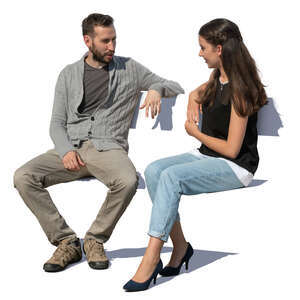 man and woman sitting outside and talking