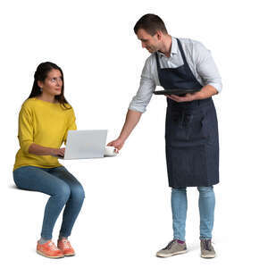 waiter bringing coffee to a woman sitting at a table