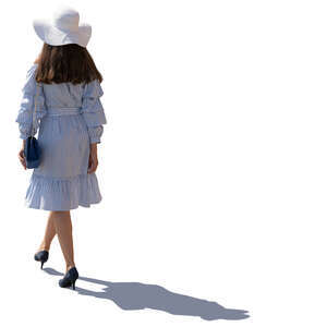 backlit image of a woman in summer dress walking