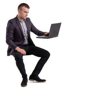 man sitting at an office table and working with computer