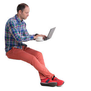 man sitting in a cafe and working with laptop