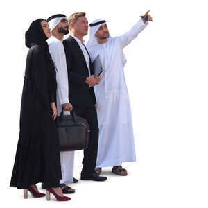 group of businesspeople in emirati standing and looking at smth