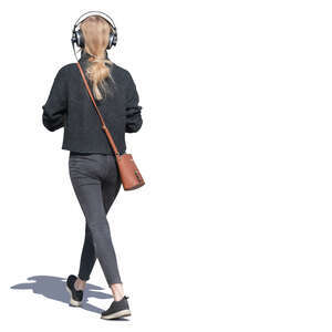 young woman with headphones walking