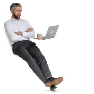 businessman sitting at a desk and drinking coffee