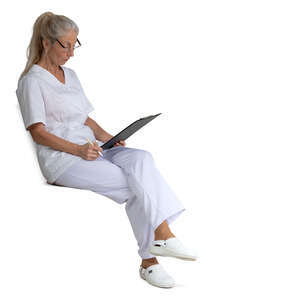 female nurse sitting and reading some papers