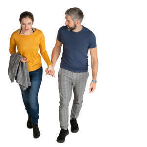 man and woman walking hand in hand seen from above