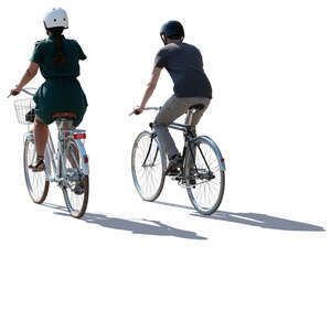 backlit man and woman cycling side by side