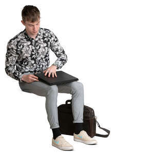 young man sitting and opening his laptop