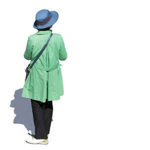 woman in a green overcoat standing seen from above