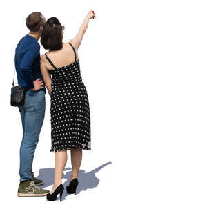 man and woman standing and pointing at smth