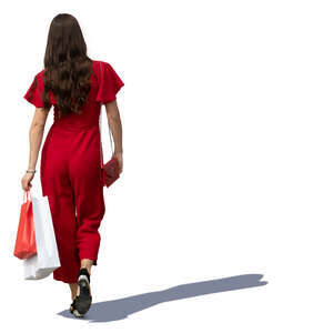 woman in a red jumpsuit walking shopping bags in hand