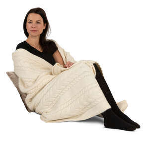 woman wrapped in a blanket sitting on a sofa