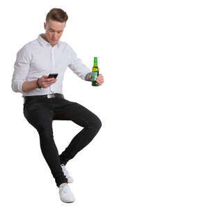 young man sitting in a bar and drinking beer