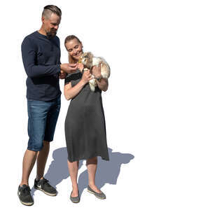 man and woman standing and feeding a rabbit