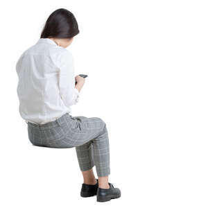 woman sitting and browsing her phone