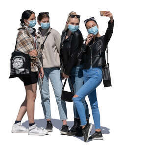 four girls with face masks standing and taking a selfie