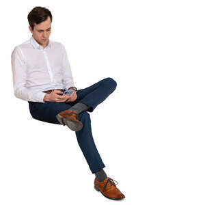 man sitting and browsing his phone