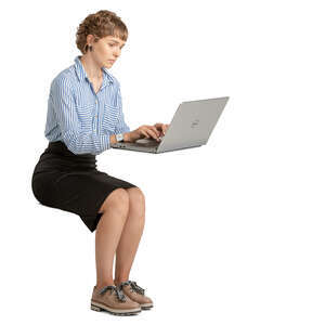woman sitting and working on a laptop