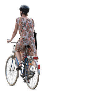 woman in a summer dress riding a bike