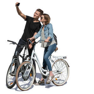 young man and woman stopping while biking to take a selfie