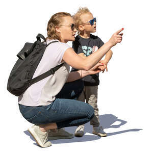 woman squatting and showing something to her son