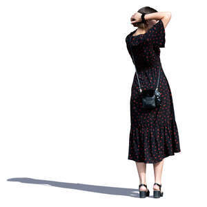 woman in a long summer dress standing and looking around