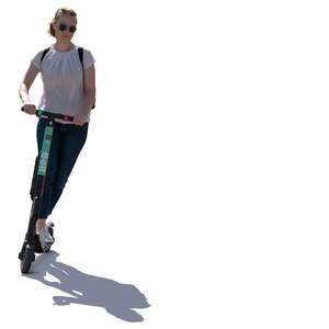 backlit woman riding an electric scooter