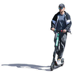 cut out sidelit young man riding an electric scooter