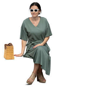 cut out woman in a green dress sitting