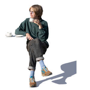 young man sitting in a cafe and drinking coffee